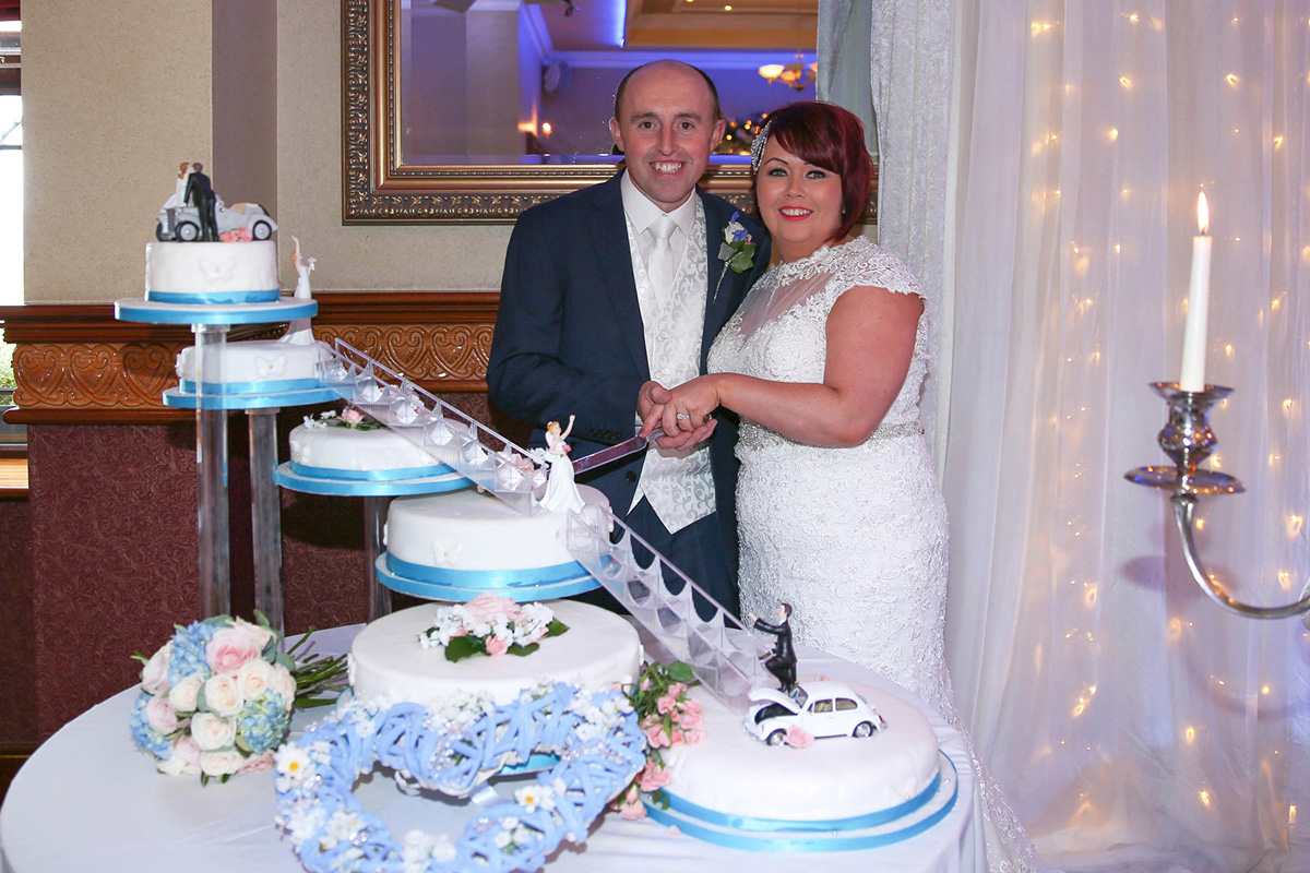 Bride and Groom cutting Wedding Cake